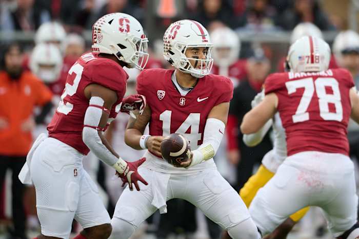 Nov 18, 2023; Stanford, California, USA; Stanford Cardinal quarterback Ashton Daniels (14) hands the ball to Stanford Cardinal running back E.J. Smith (22) against the California Golden Bears during the first quarter at Stanford Stadium. Mandatory Credit: Robert Edwards-USA TODAY Sports